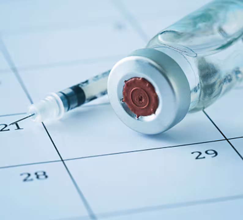 Calendar and syringe with a vaccine vial