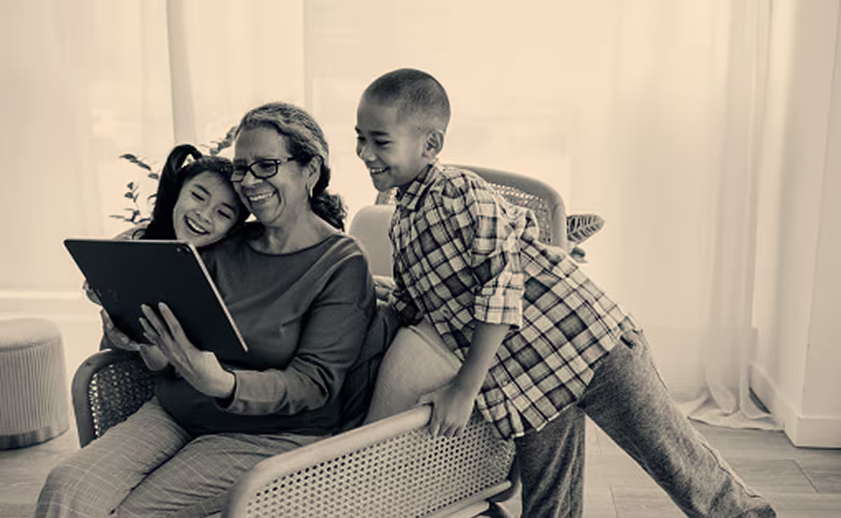 Grandmother and children looking at a tablet together